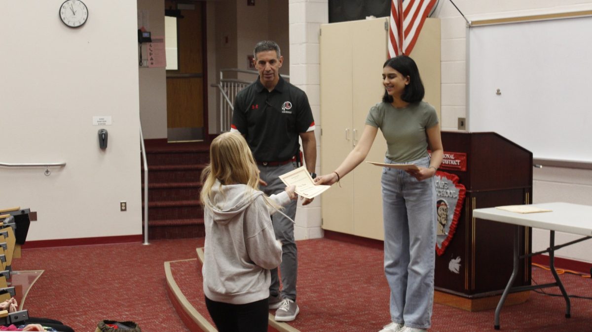 Mr. Cattani and Radhika Soni handing out certificates for the completion of the Phone Detox Challenge. 